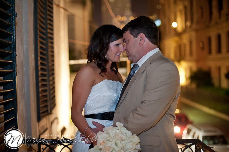 bride and groom on french quarter balcony