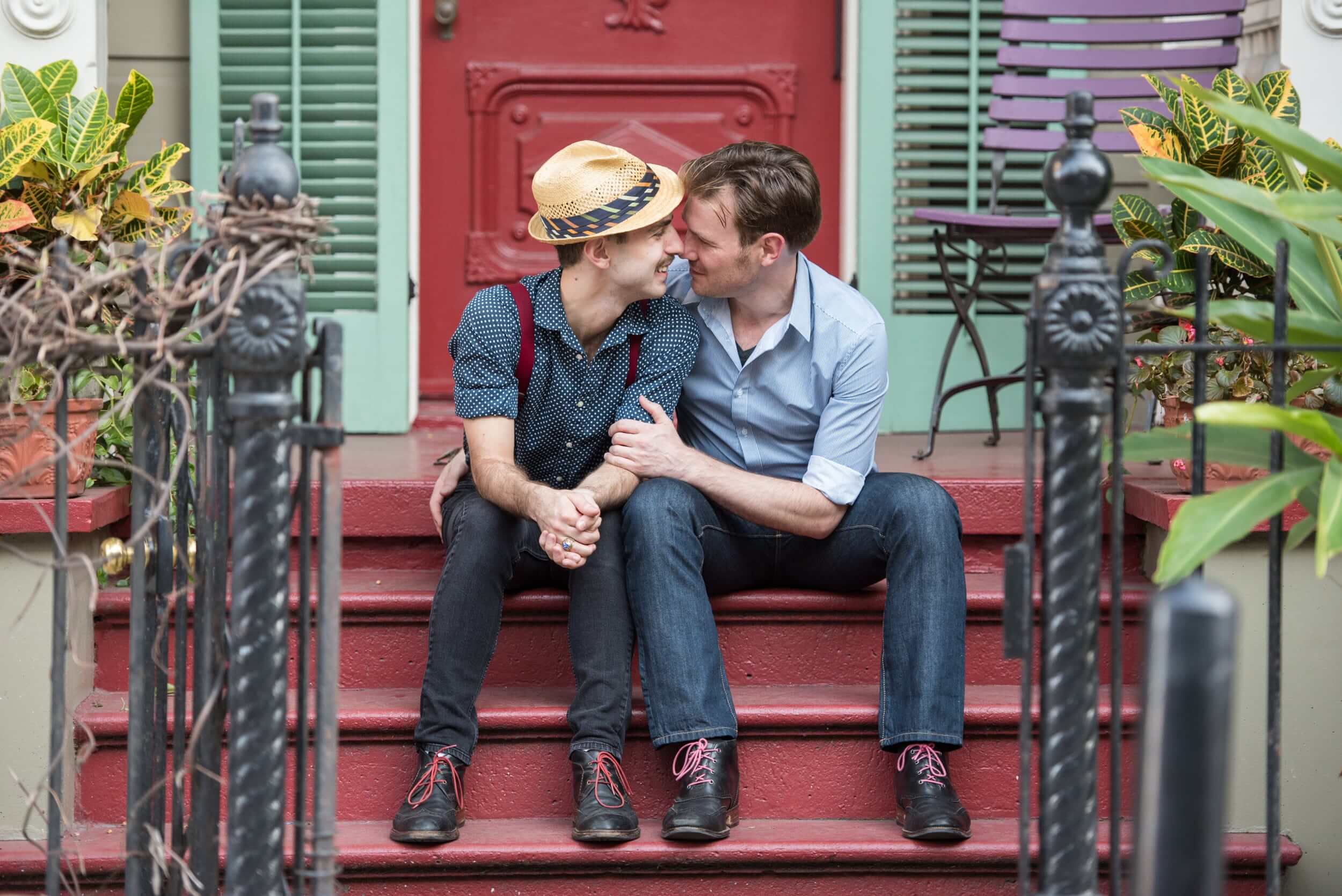 Gay couple on French Quarter red steps during a New Olreans engagment session.