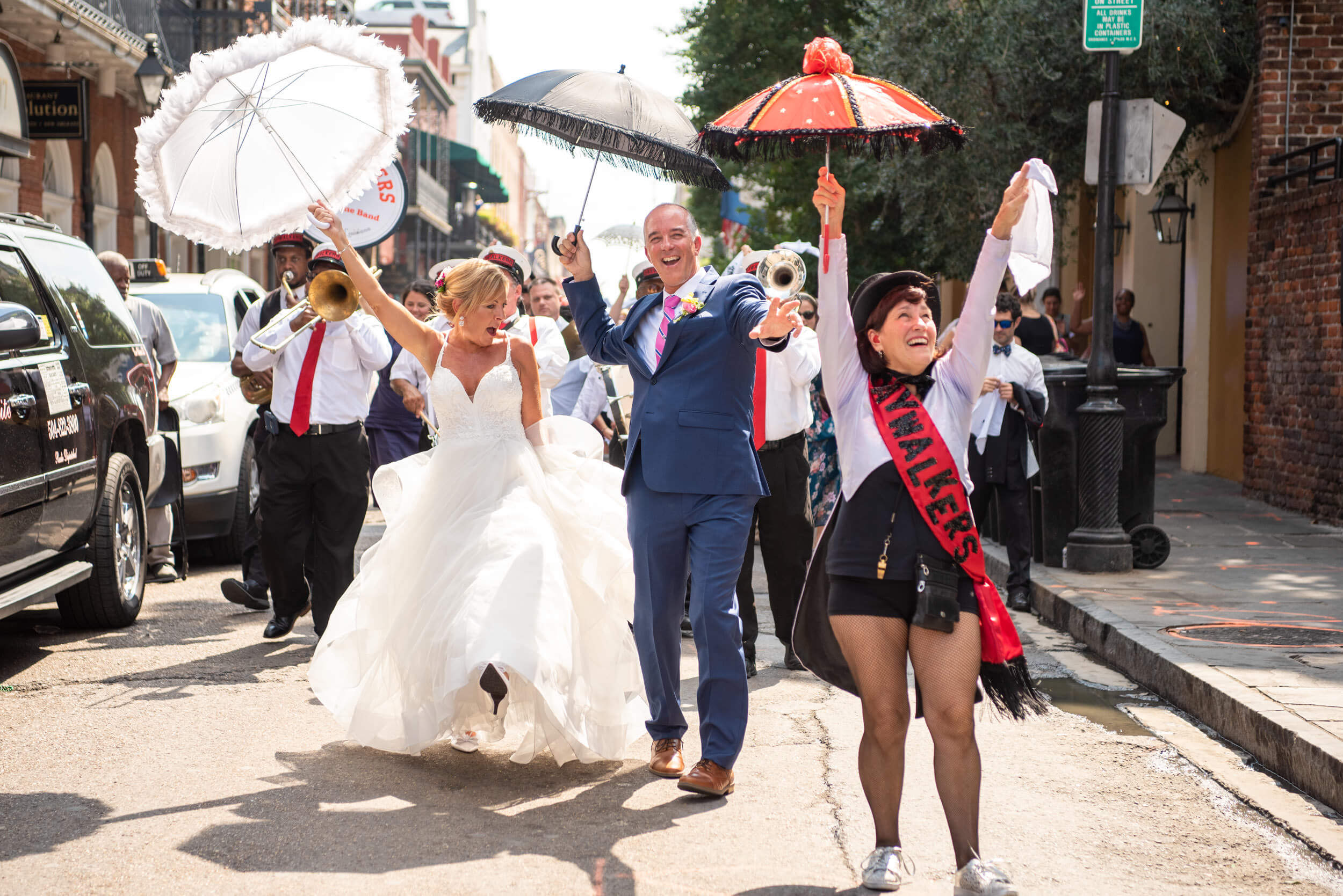 New Orleans wedding secondline parade featuring The Jaywalkers. Captured by New Orleans wedding photographers from The Red M Studio.