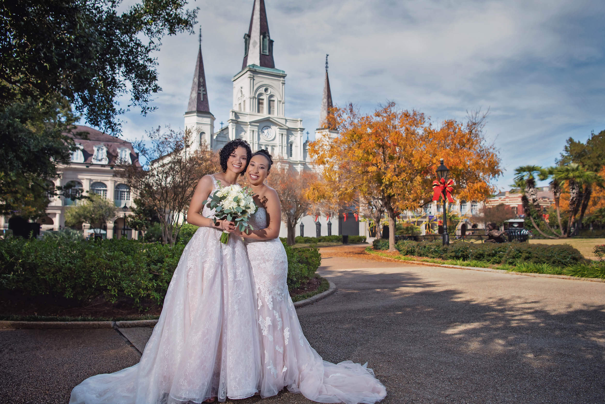 Lesbian brides in Jackson Square with New Orleans' St. Louis Cathedral in the background