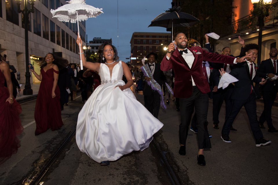 African American couple leading their New Orleans wedding second line parade